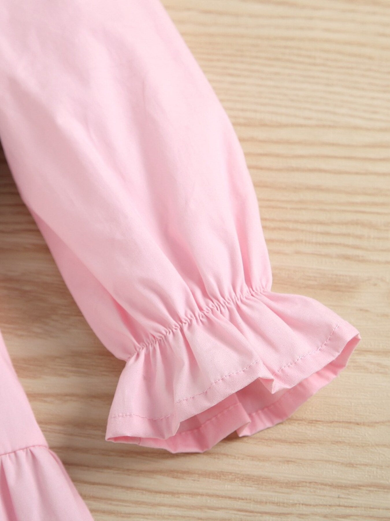 Pink cotton toddler dress sleeve with ruffled cuff detail