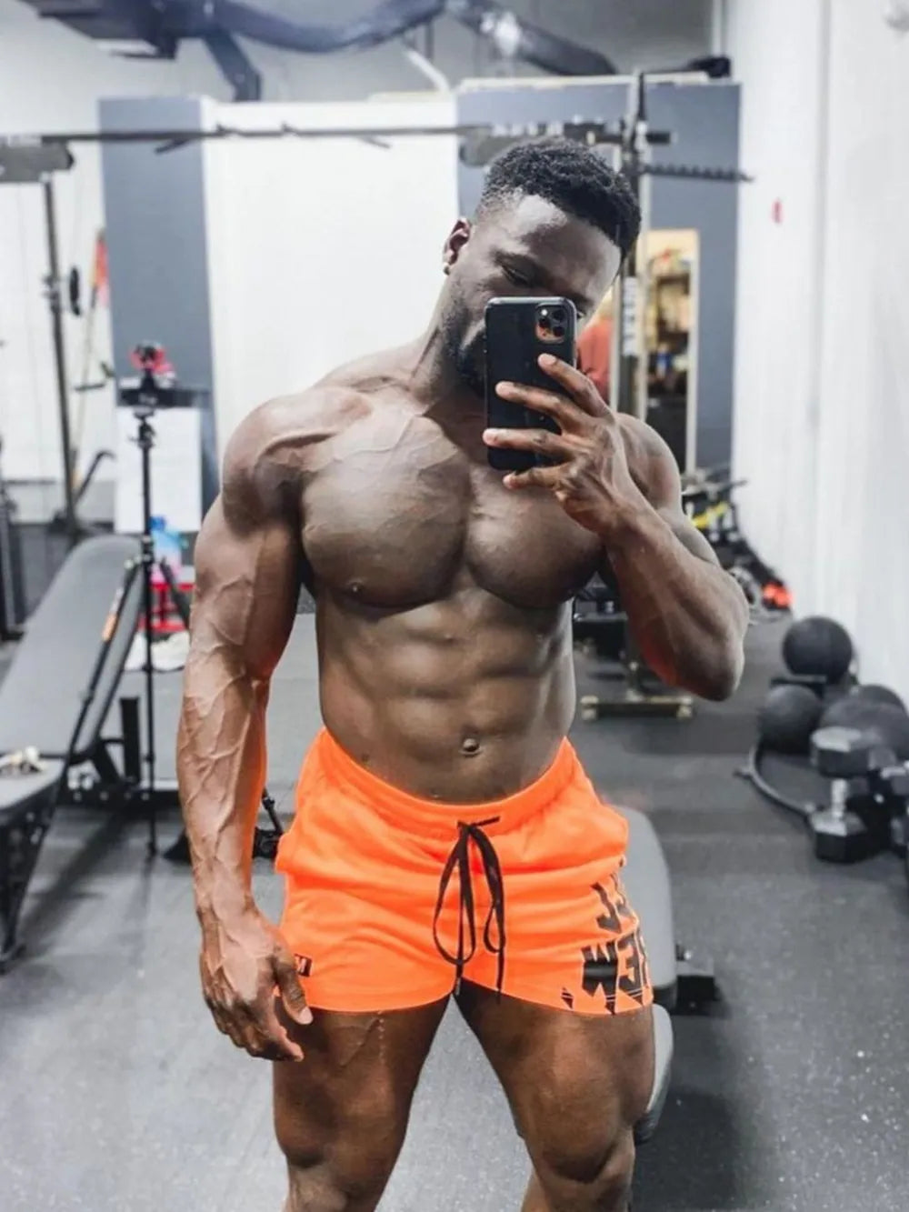 Crew graphic performance shorts in tangerine with black drawstring and graphic detail.