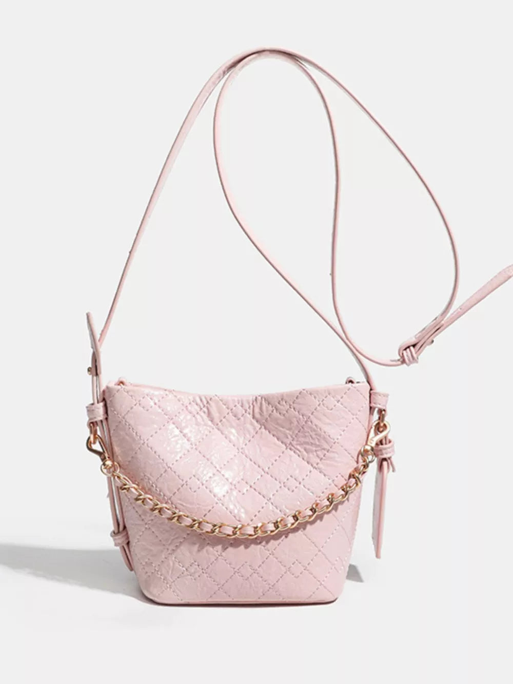Pink quilted bucket bag with gold chain accent and adjustable strap