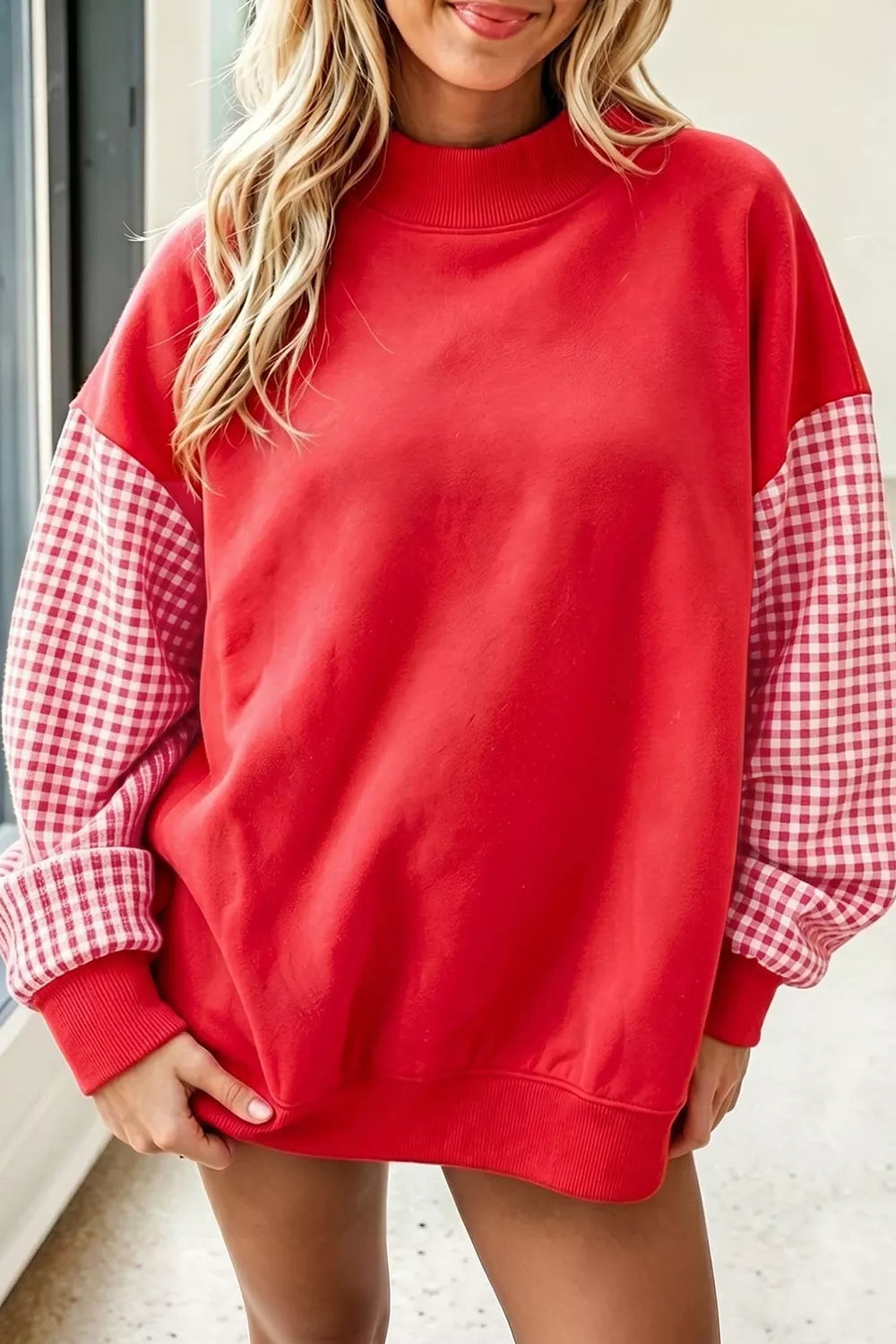 Red sweatshirt featuring ribbed cuffs and color-block