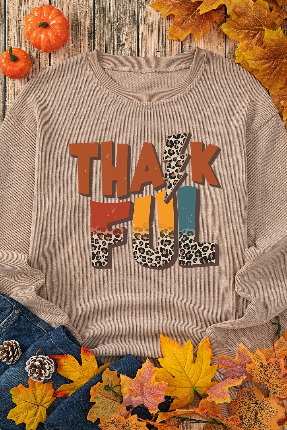 Textured ribbed camel sweatshirt with "Thankful" graphic featuring leopard print and lightning bolt details.