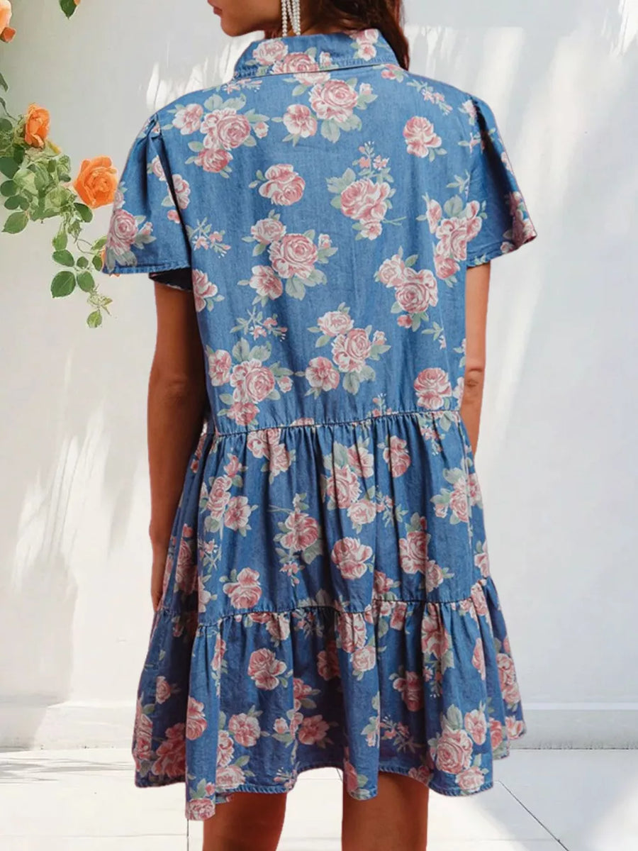 Light blue floral denim mini dress with ruffled tiers and short sleeves.