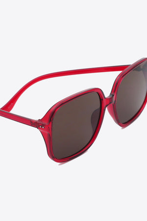 Red square frame sunglasses with brown lenses and translucent arms.