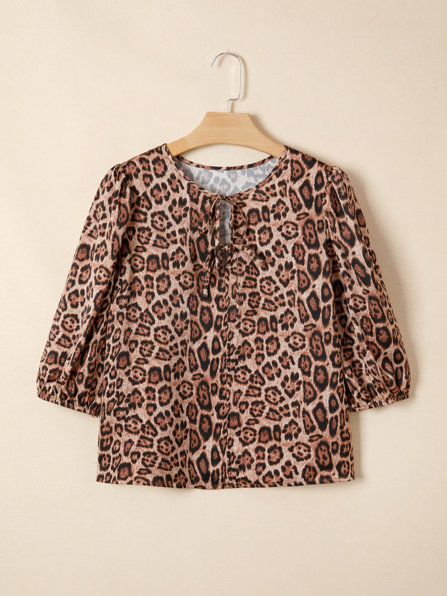 Leopard print blouse with puff sleeves and a tie-neck detail