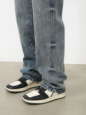 Vintage wash wide-leg denim jeans in dusty blue, styled with sneakers.
