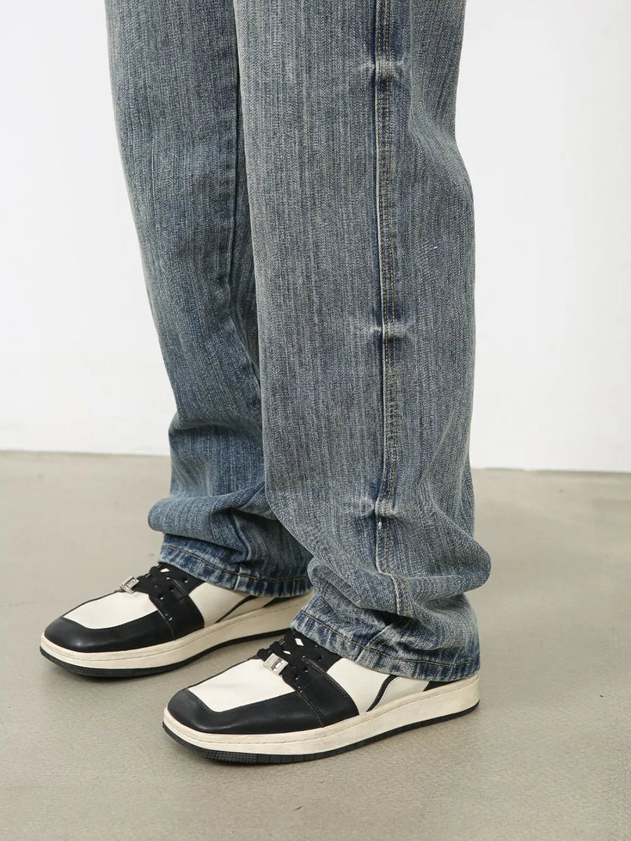 Vintage wash wide-leg denim jeans in dusty blue, styled with sneakers.