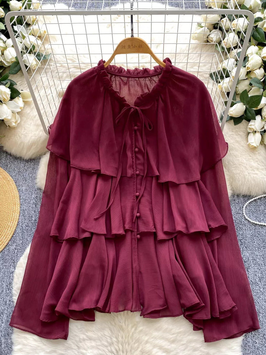 Burgundy chiffon tiered blouse with ruffled details and bow tie neckline.
