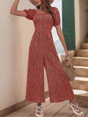 Smocked bodice floral print jumpsuit with puff sleeves and wide legs.