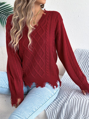 v-neck sweater in bright orange with cable knit and distressed