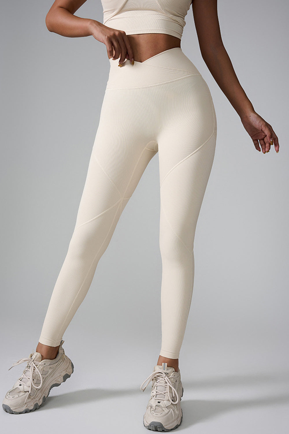 Ivory ribbed contour leggings with v-waist and seam detail.