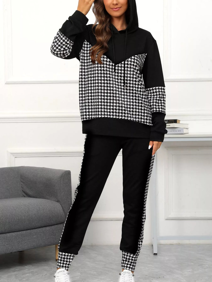 Black houndstooth hoodie and pants set with drawstring and patterned cuffs and side stripes.