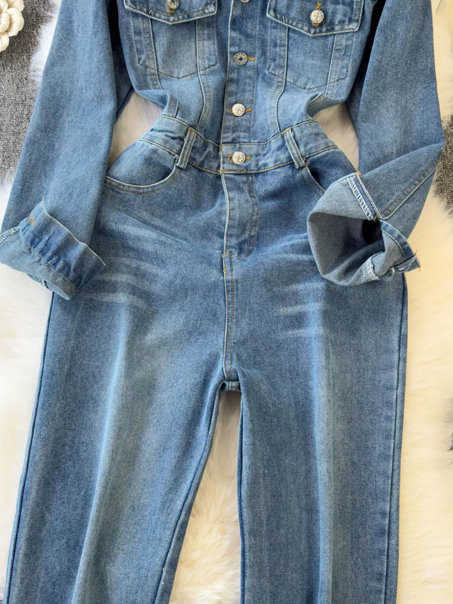 Chic buttoned denim jumpsuit with pockets and cuffed sleeves.