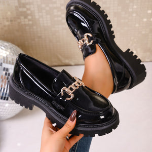 Gloss black patent chunky lug sole loafers with gold chain detail.