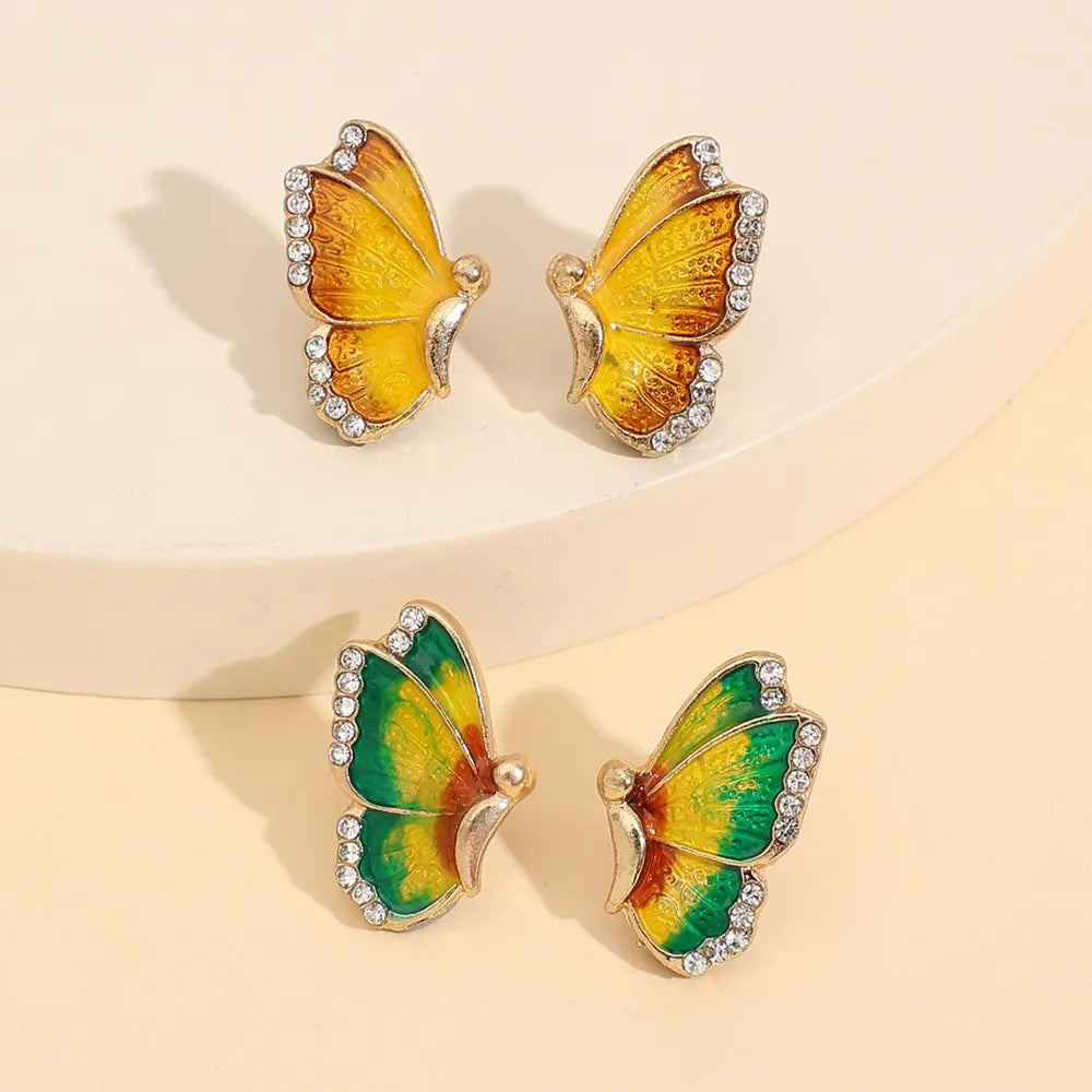 Enamel winged stud earrings with crystals in yellow and multicolor butterfly designs.