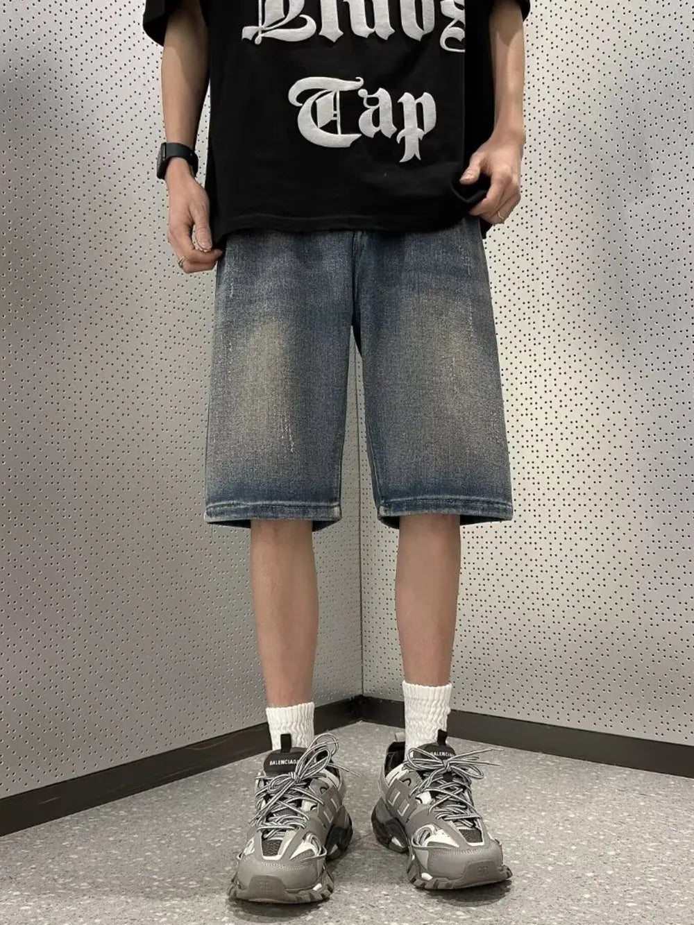 Men's vintage wash stretch denim shorts in a medium blue wash with a relaxed fit.