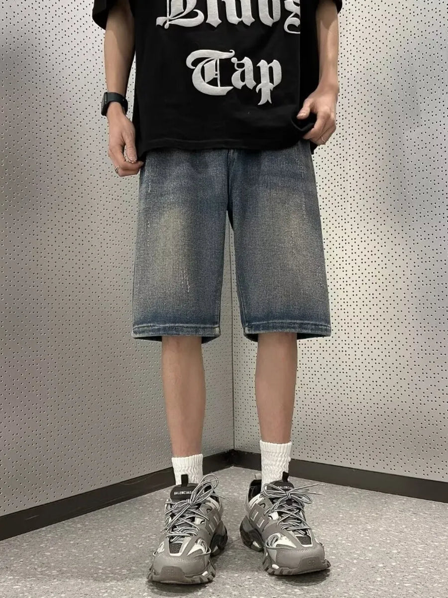 Men's vintage wash stretch denim shorts in a medium blue wash with a relaxed fit.