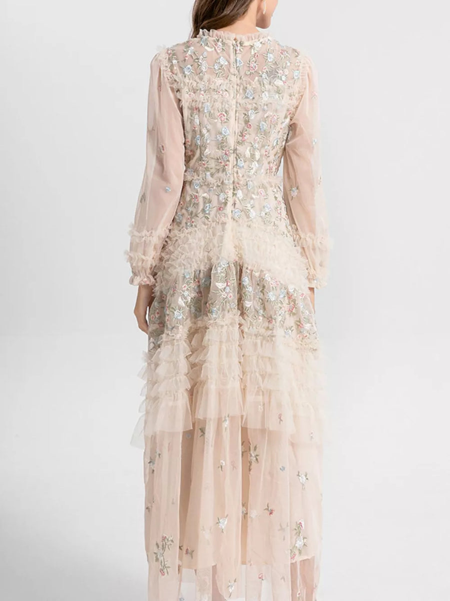 Embroidered floral tulle maxi gown with tiered ruffles and long sleeves.