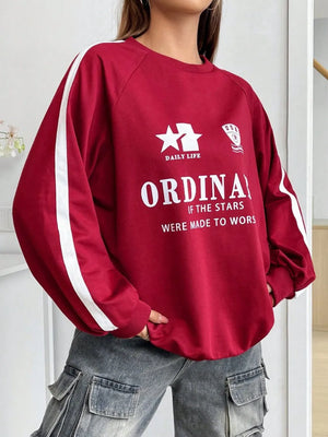 Deep red raglan sleeve sweatshirt with white stripe details and graphic print.