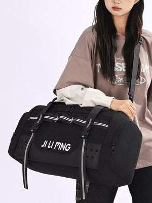 Spacious black Oxford cloth travel tote bag with white stripe details and side pockets.