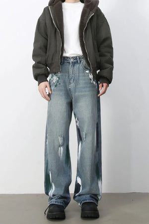 Ink-Blot Wide Leg Denim jeans in medium wash with abstract paint splatters and distressed details.
