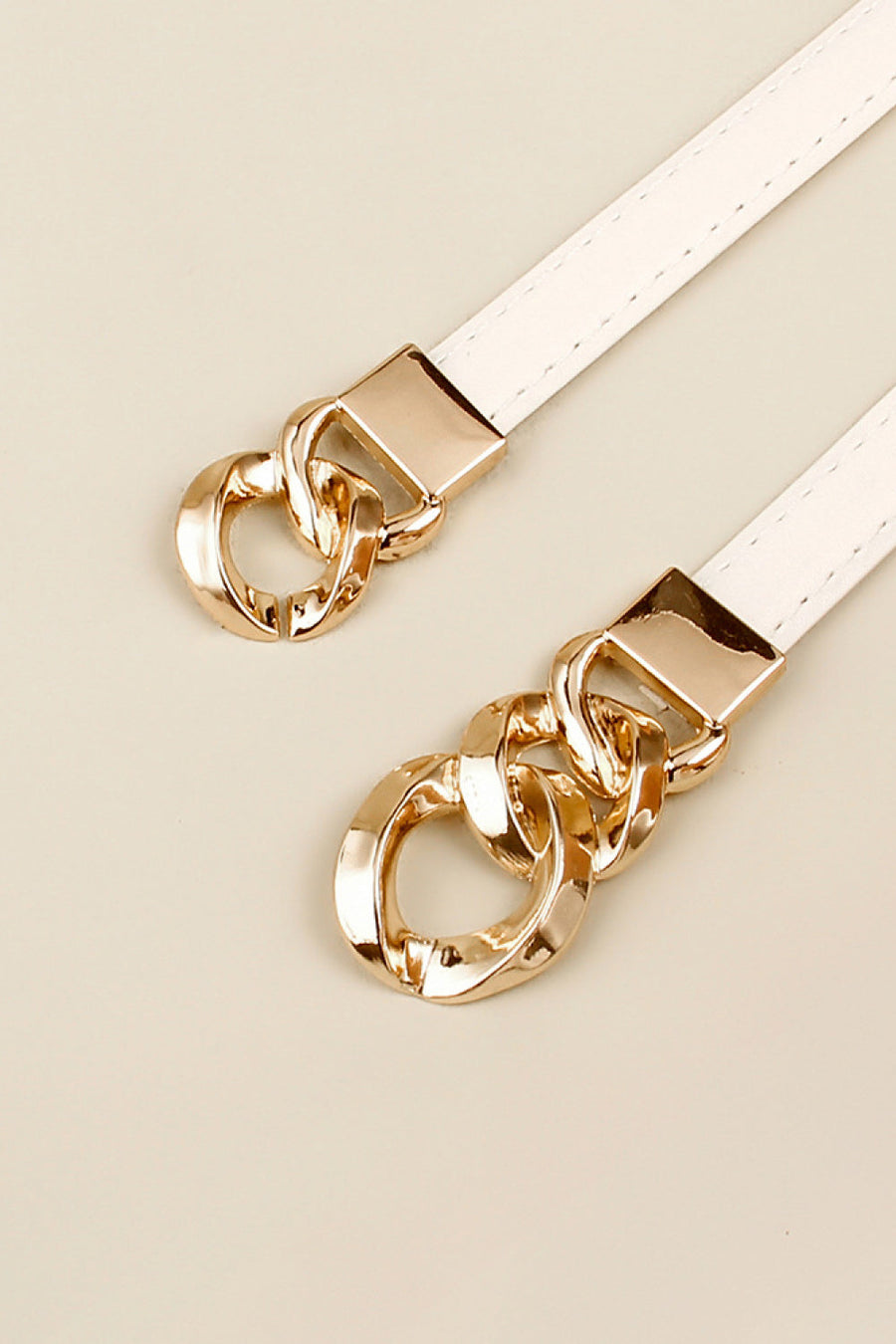 White belt with gold chain link buckle detail