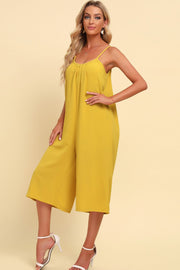 Yellow culotte jumpsuit with gathered bodice and spaghetti straps.