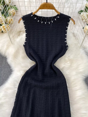 Black textured knit midi dress with pearl neckline and armhole details.