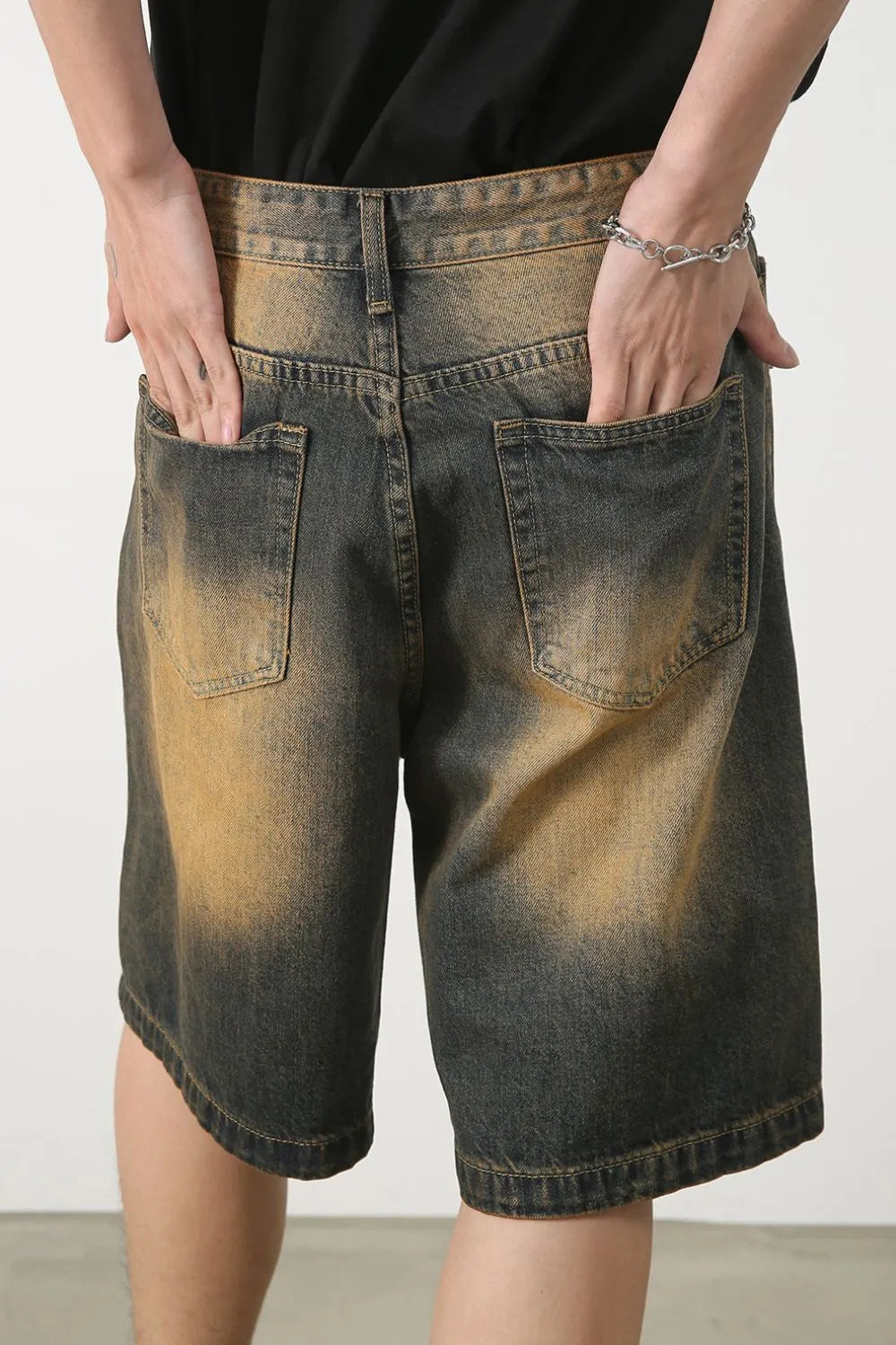 Two-tone washed denim bermuda shorts in olive brown with a faded effect.