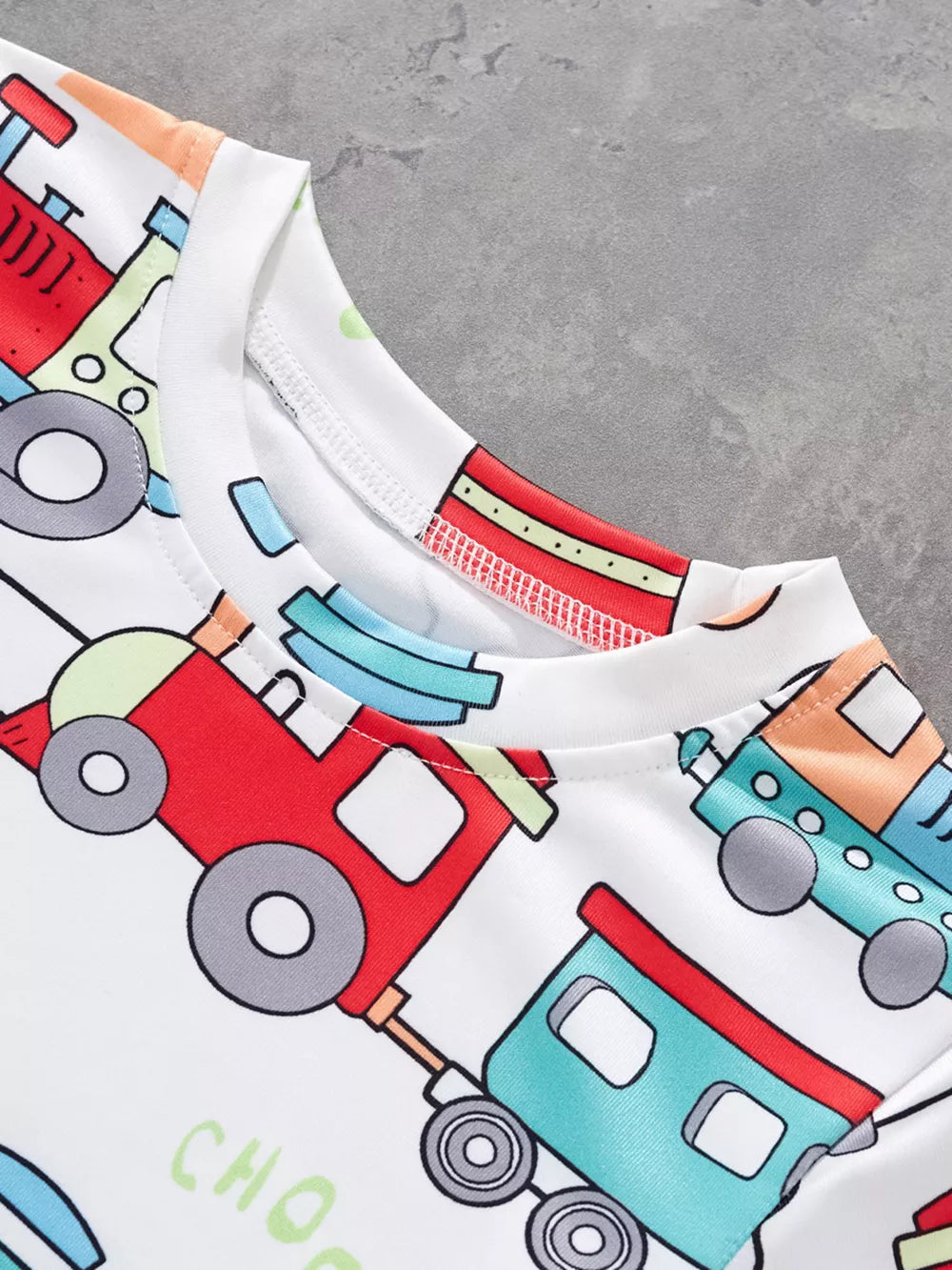 White t-shirt with colorful train print and crew neck.