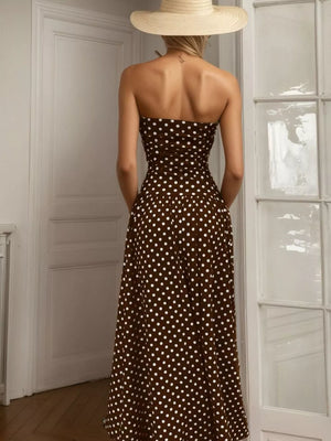 Brown polka dot strapless maxi dress with a flowing skirt.