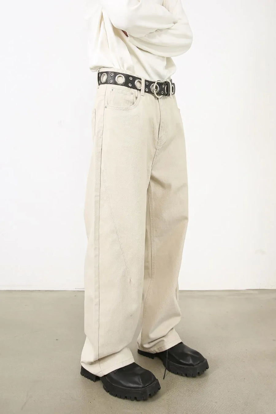 Oversized beige denim jeans with a sculpted leg and neutral wash.