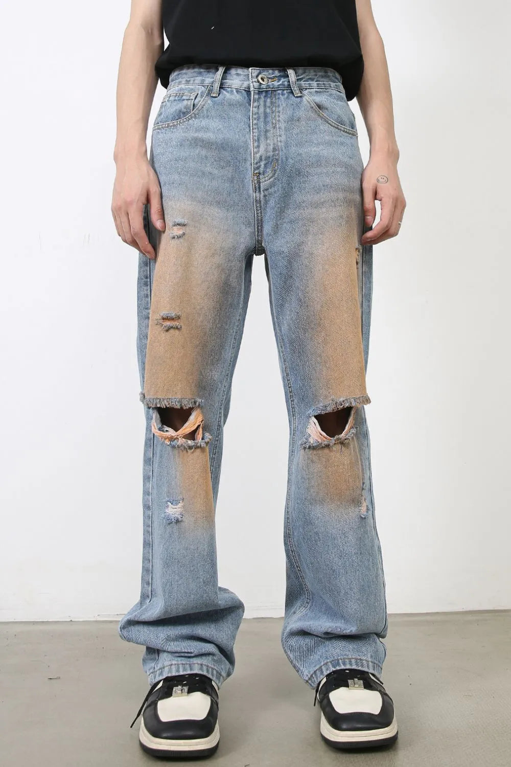 Light blue wide leg denim jeans with faded wash, distressed details, and ripped knees.