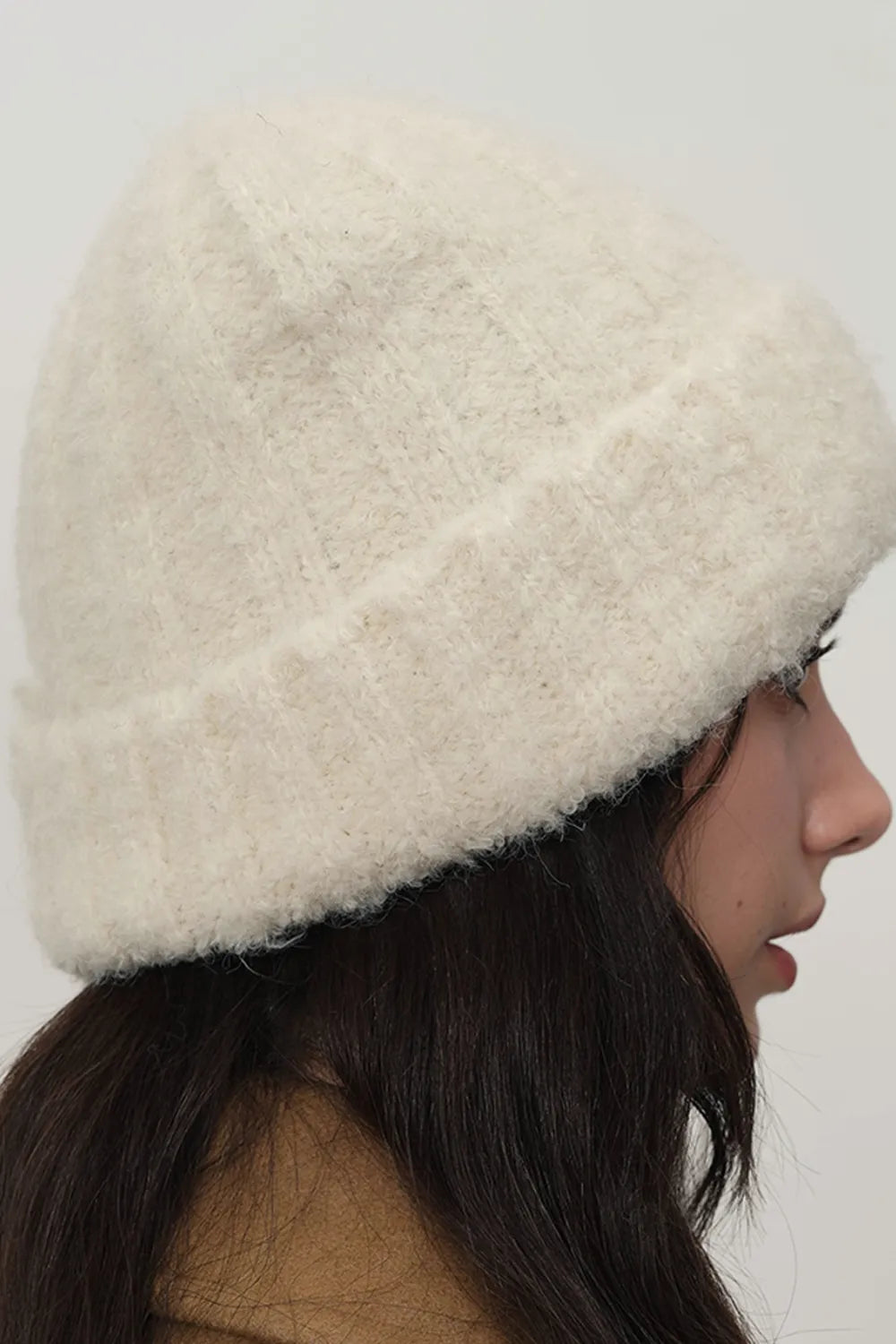 Cream textured bouclé knit beanie with a cuffed brim.