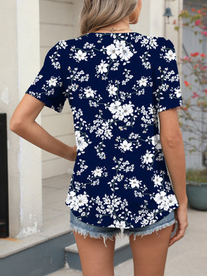 Women's dark blue floral print short sleeve blouse with a v-neck.