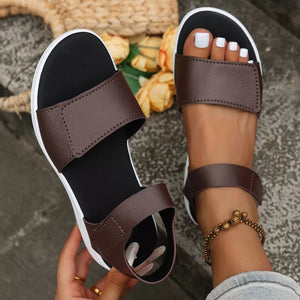 Brown adjustable platform sandals with open toe and chunky sole.