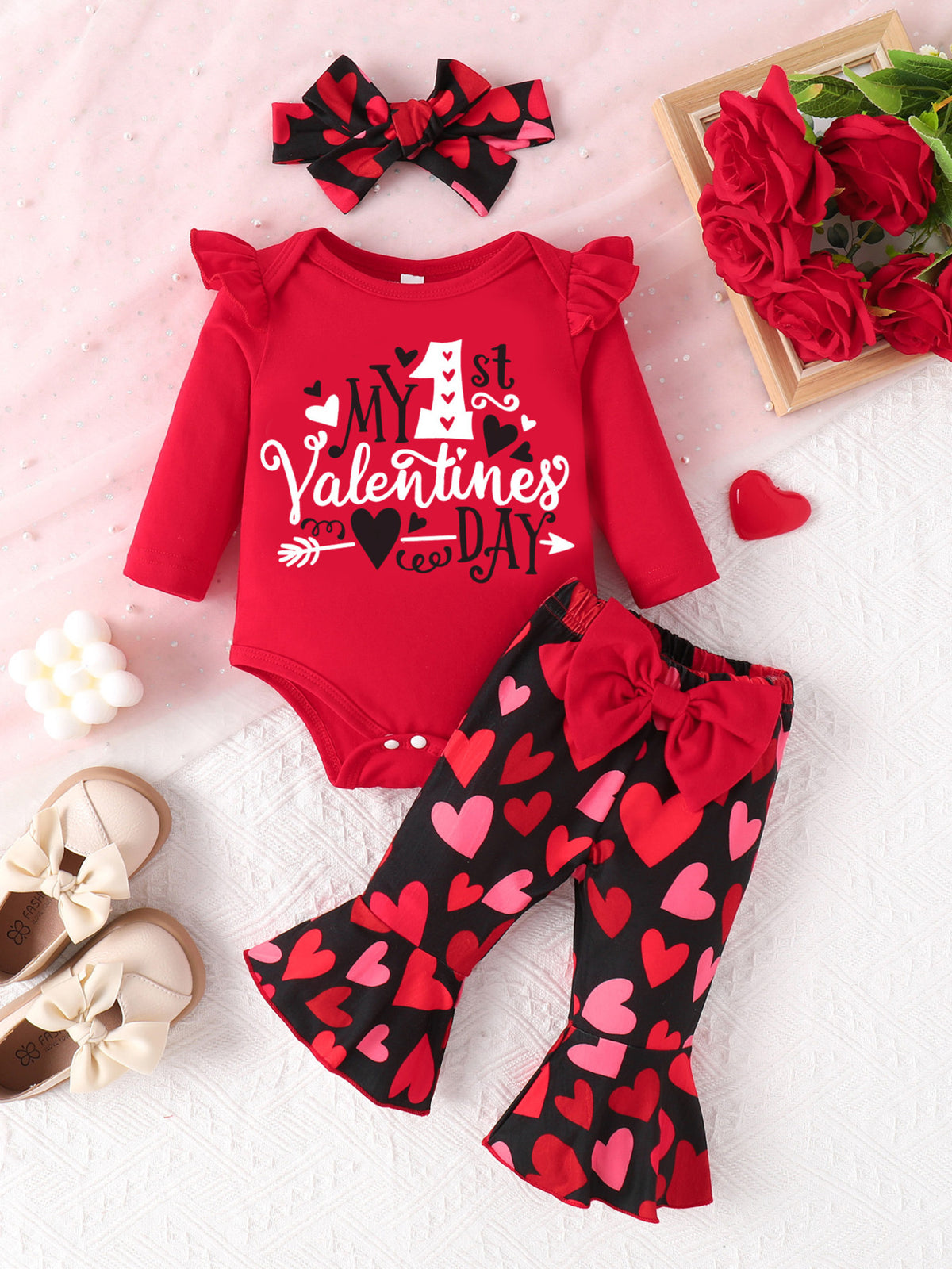 Red baby Valentine's Day set with heart print bell bottoms and ruffled sleeves.