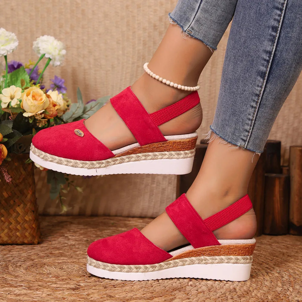 Red espadrille wedge slingback sandals with elastic straps and espadrille trim.