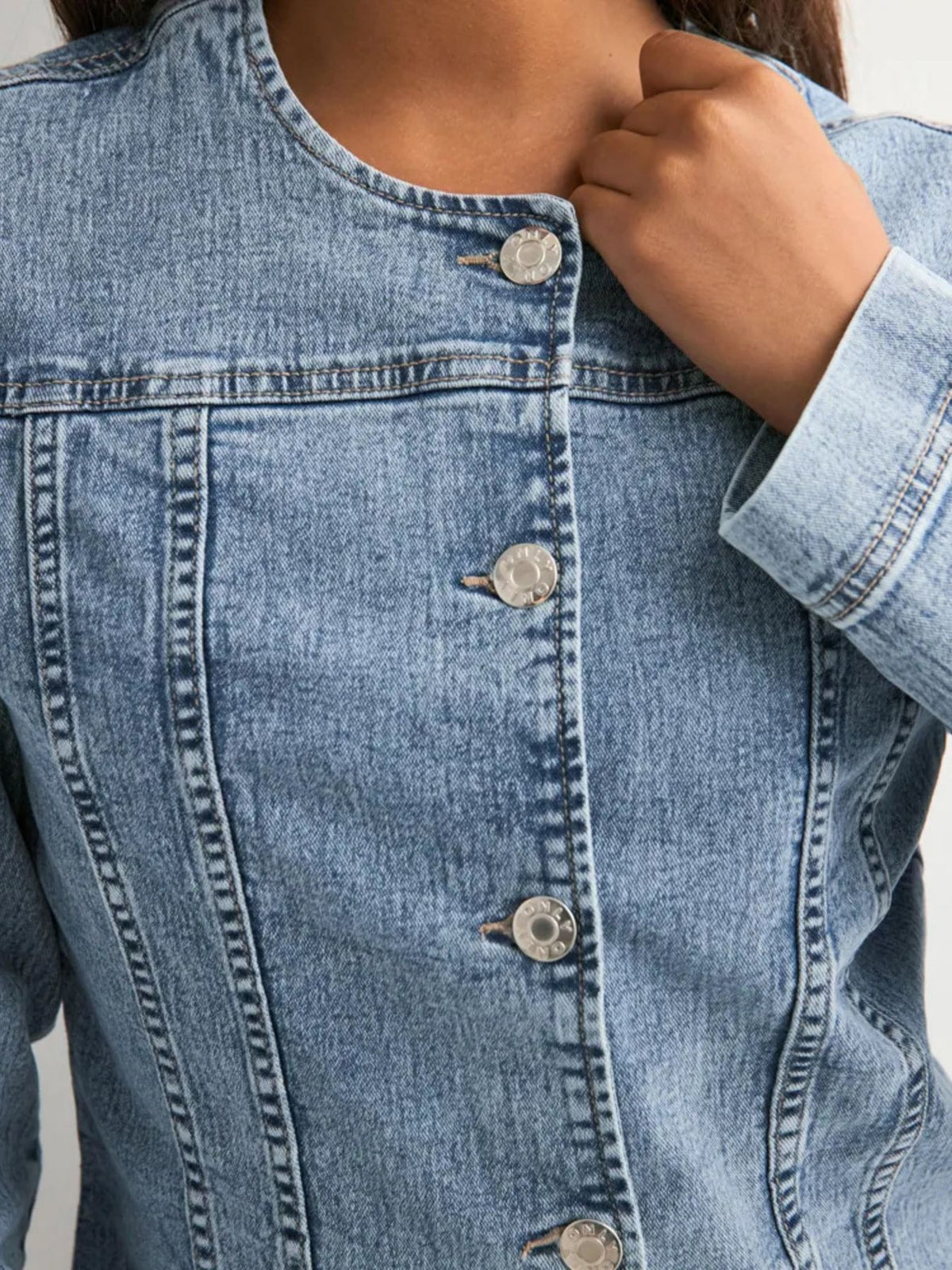 Button-down denim jacket with seam detailing and a collarless neckline.