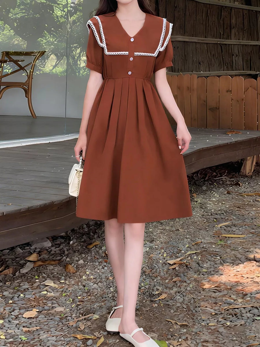Brown short sleeve dress with lace sailor collar and decorative buttons.