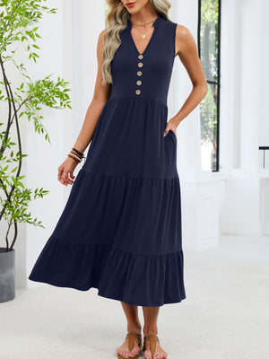 Navy tiered midi dress with notched V-neck and decorative buttons, sleeveless with pockets.
