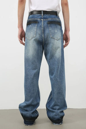 Panelled denim palazzo trousers in medium wash with distressed details and wide legs.