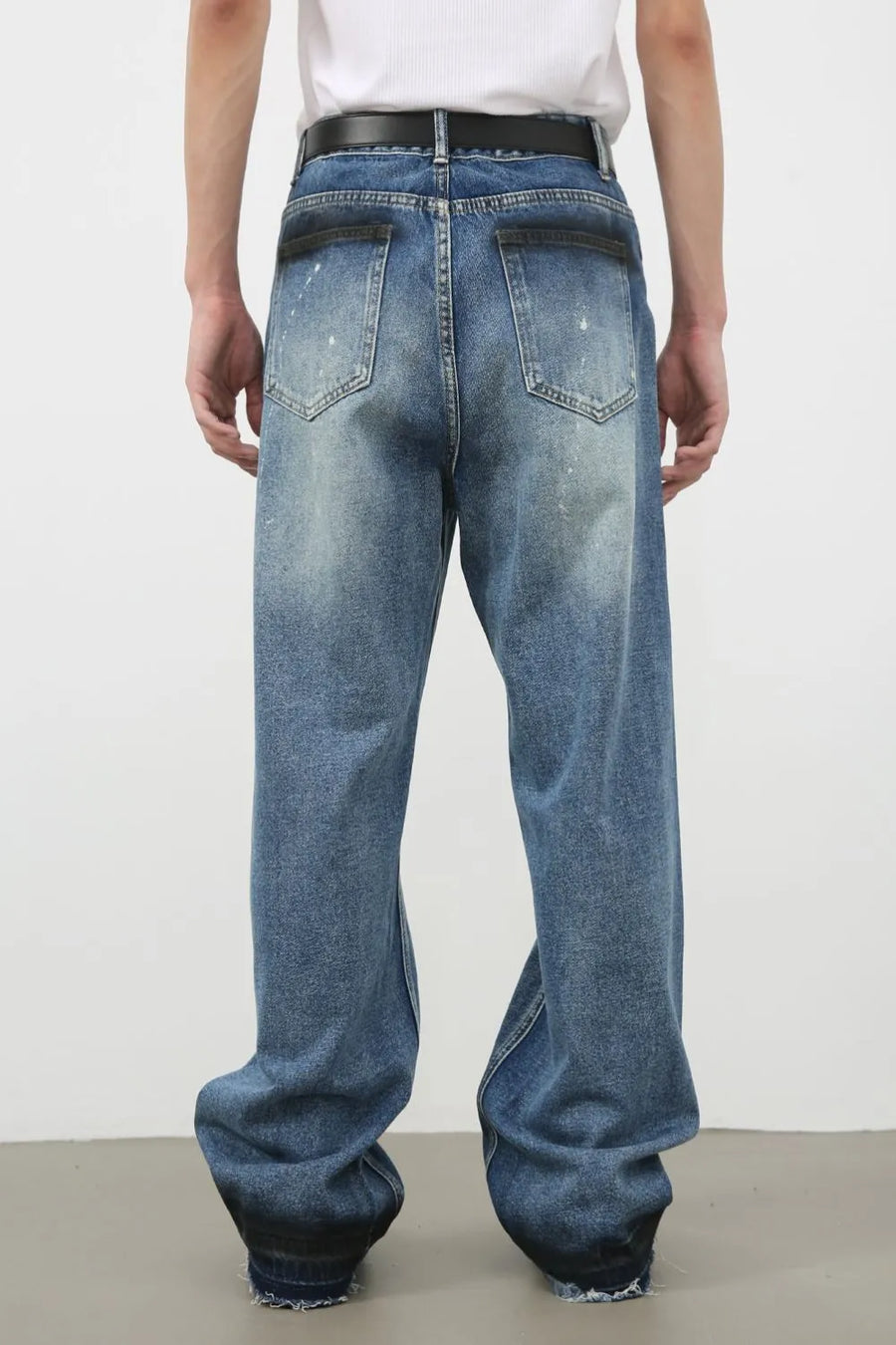 Panelled denim palazzo trousers in medium wash with distressed details and wide legs.