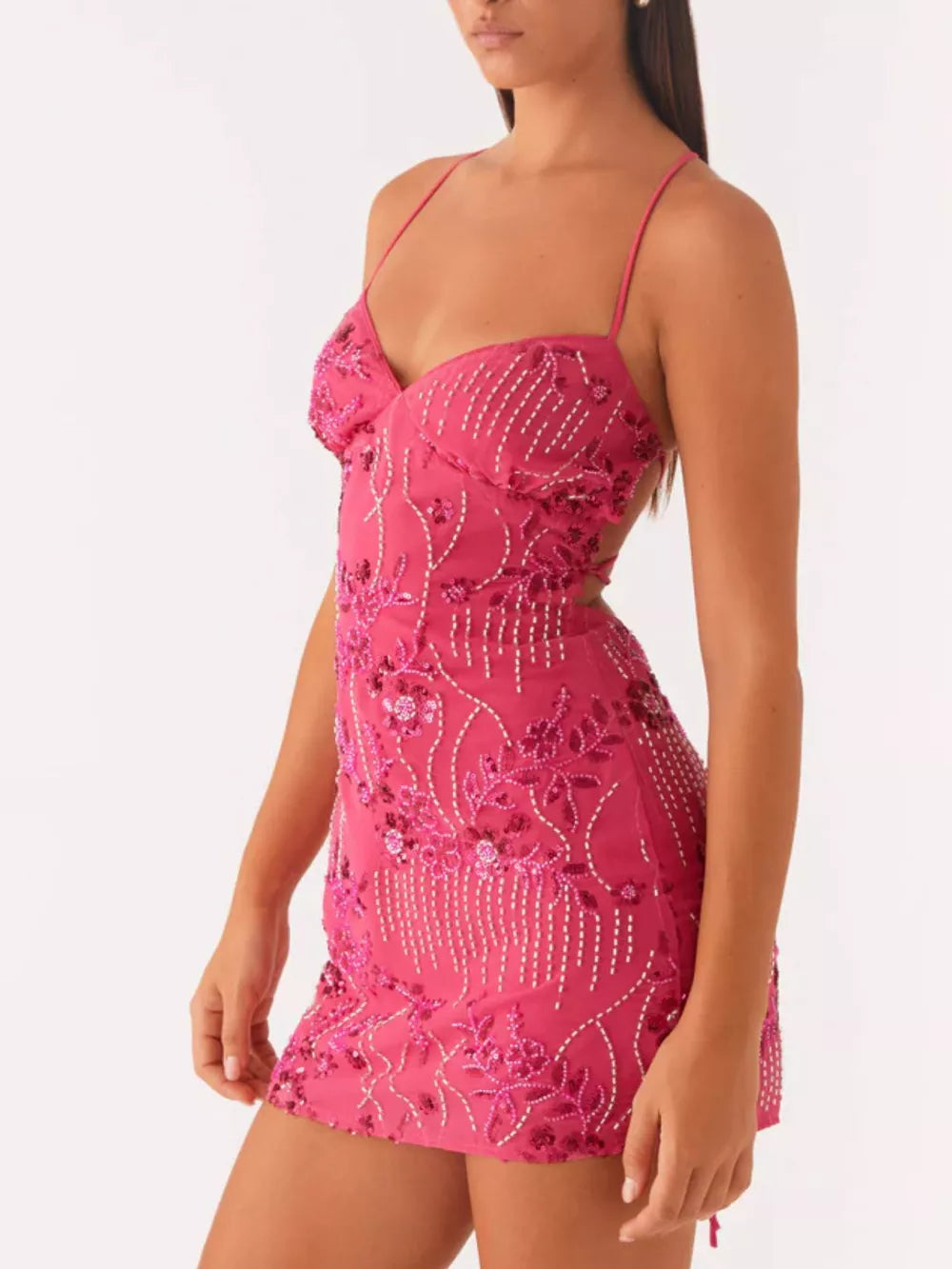 Fuchsia pink mini dress with floral embellishments and beaded details.