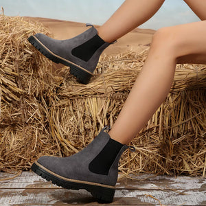 Gray suede platform ankle boots with elastic side panels and chunky sole