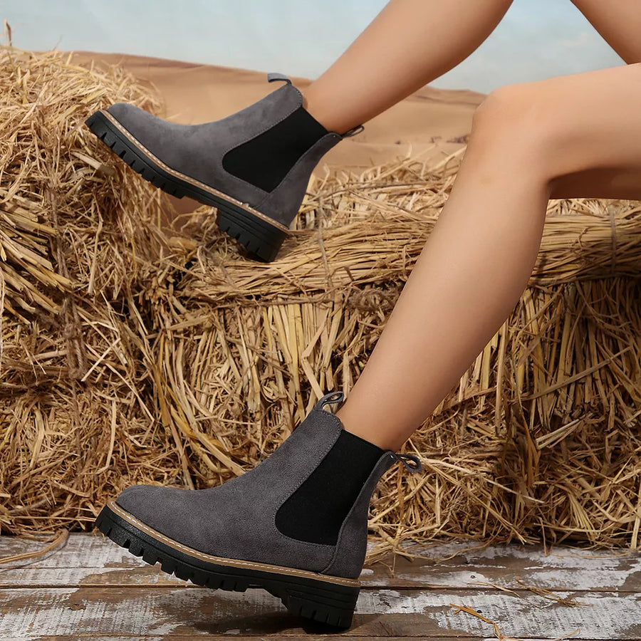 Gray suede platform ankle boots with elastic side panels and chunky sole