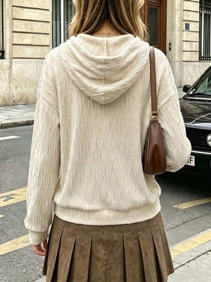 Textured cream hoodie with dropped shoulders and drawstring hood.