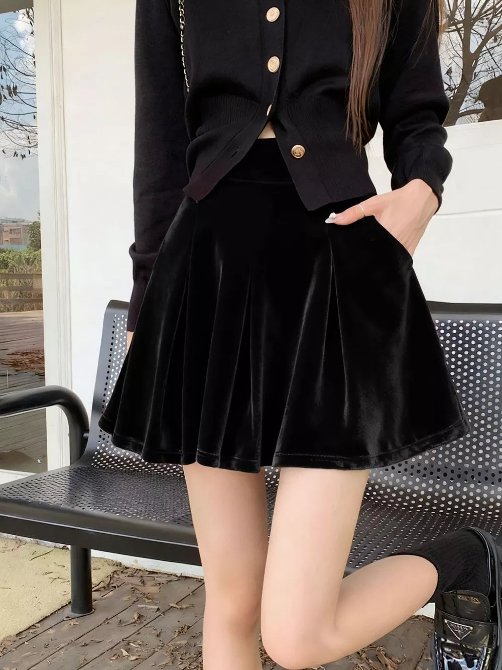 Black velvet A-line skort with pockets and pleated detail.