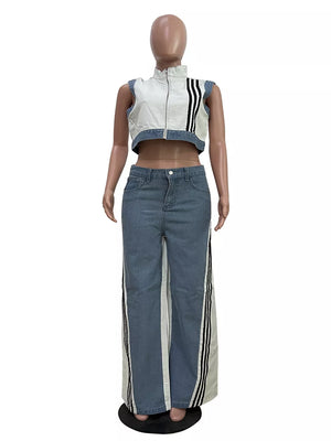 White zip-front crop top with black stripes and wide-leg jeans with side stripe detail.