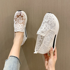 White lace mesh slip-on flats with floral pattern and white sole.