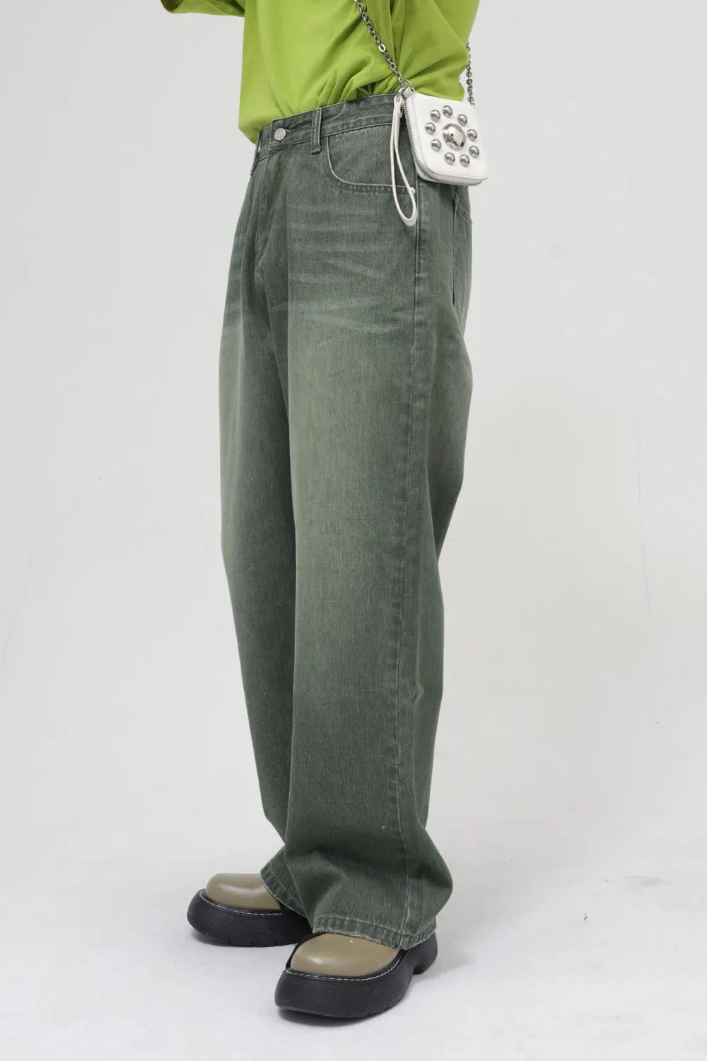 Faded olive relaxed wide leg denim jeans with a faded wash.